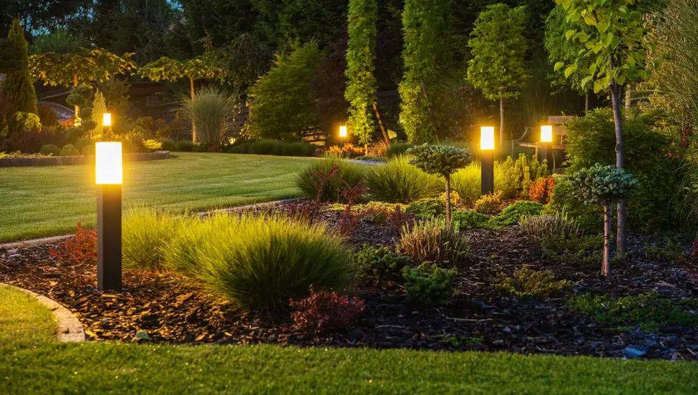 Garden path lighting illuminating a walkway with soft, warm lights along the edges, enhancing the natural beauty of the garden in Cook & Will County, IL. The lights provide a welcoming and decorative touch, guiding the way through a lush, landscaped yard.