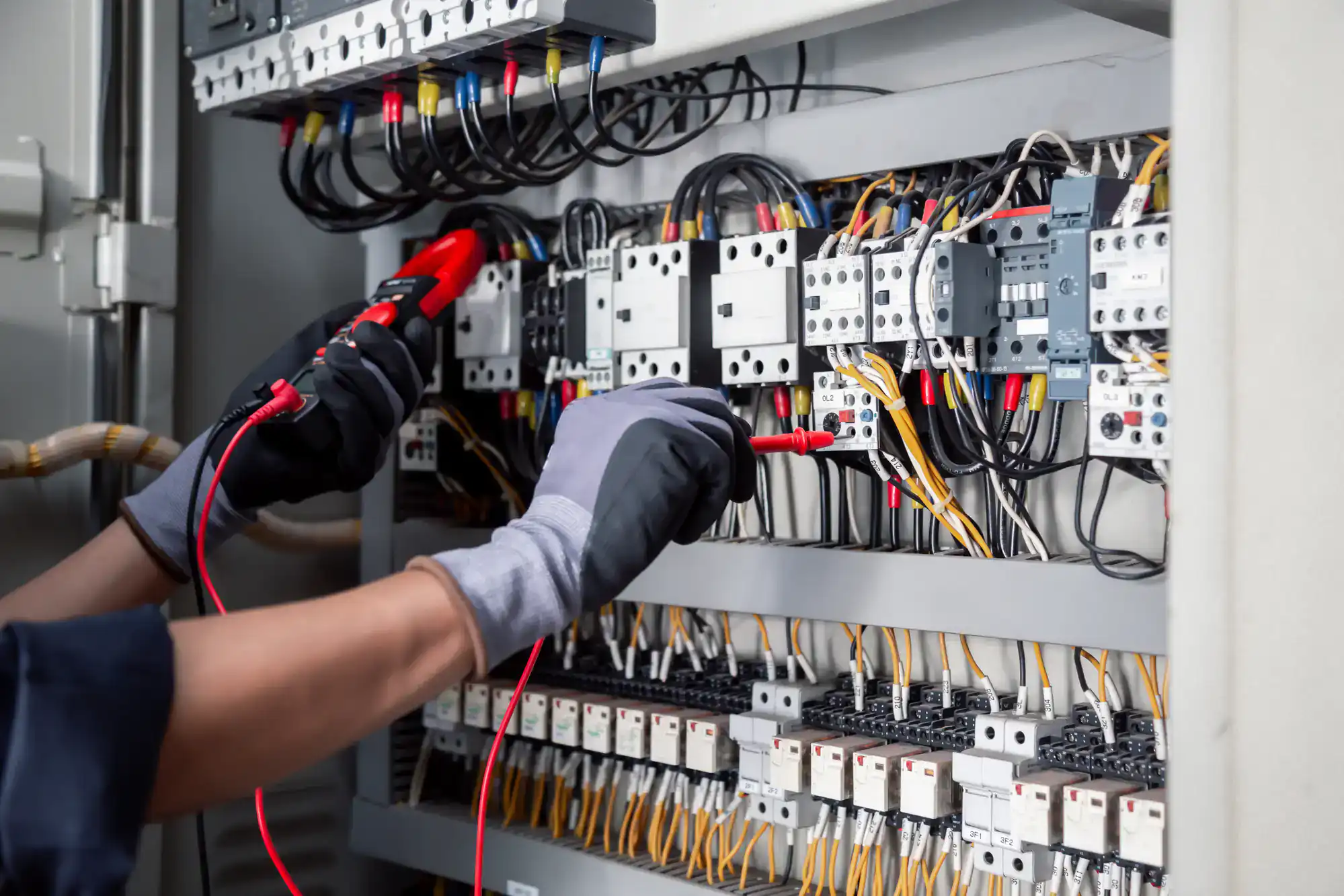 Close-up of an electrician from Jimco Electric working on a circuit panel installation in Chicago, IL. Professional electrical services for both homes and businesses.
