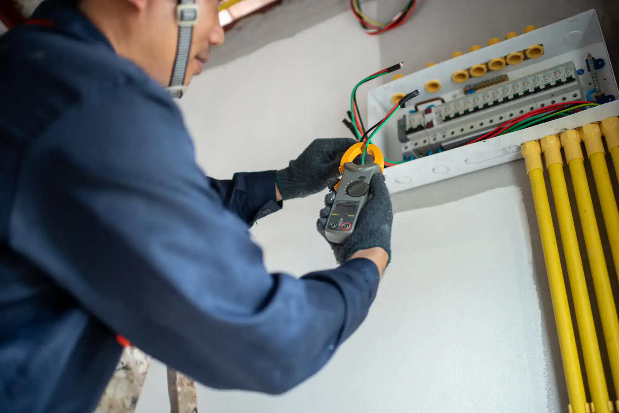 Electrician performing professional wiring installation in a residential property in Chicago, IL, ensuring safe and efficient electrical connections